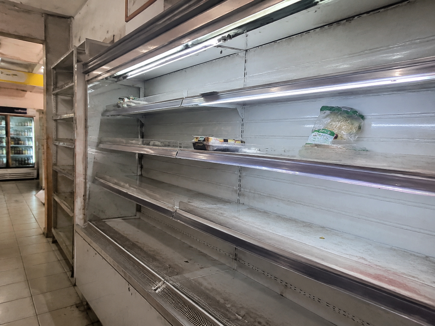 A tired, almost-empty petrol station shelf before Foodplus